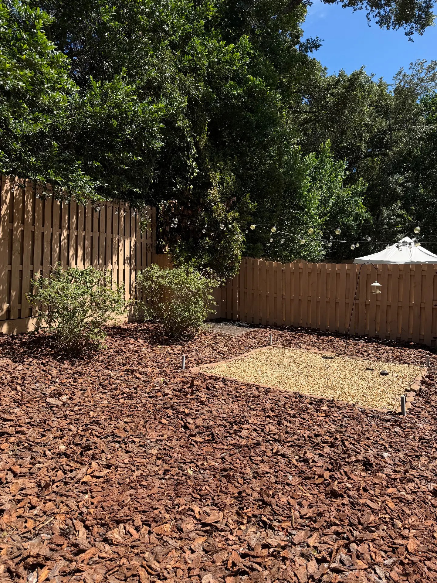 Fresh red mulch bed after cleanup and mulch installation